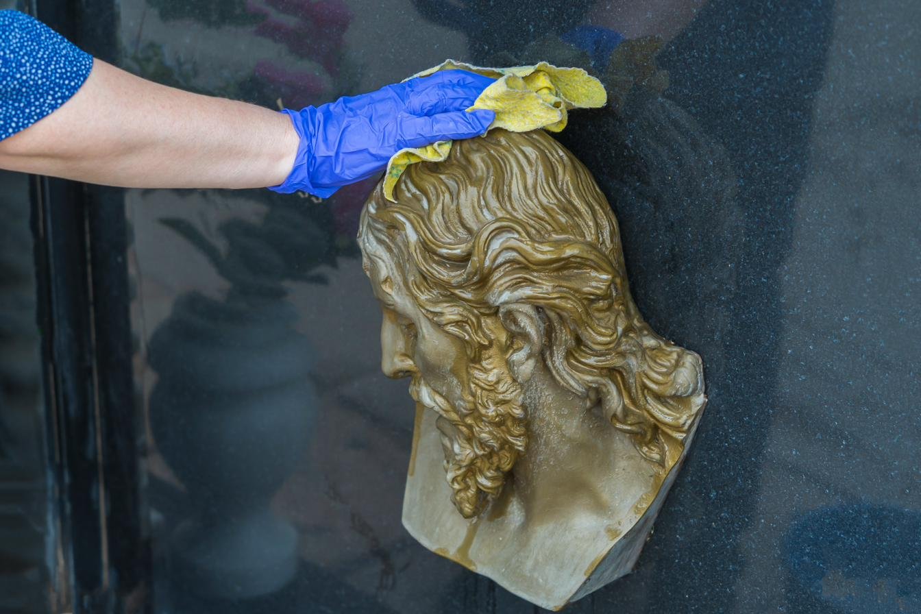 Careful bronze monument polishing